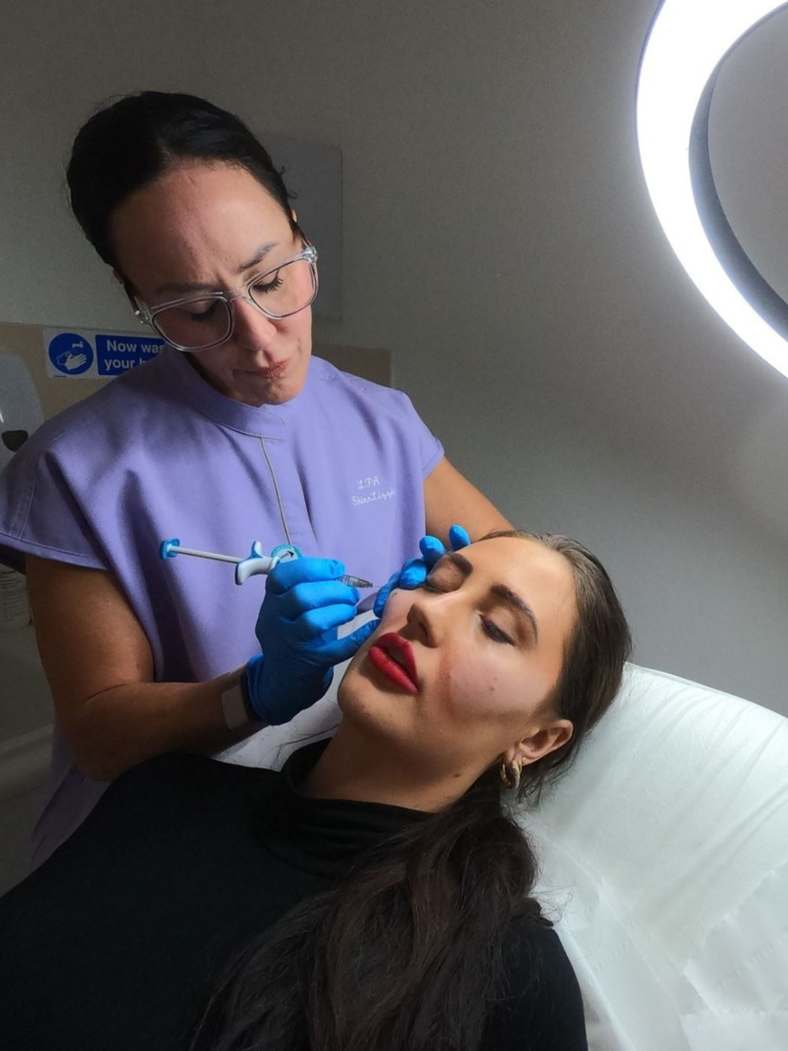 A client having an injectable treatment in her cheek