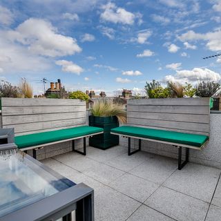 roof terrace with wooden benches and grey tile flooring