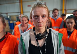 Alys (Poppy Lee Friar) works under a Big Brother-style system at the distribution centre.