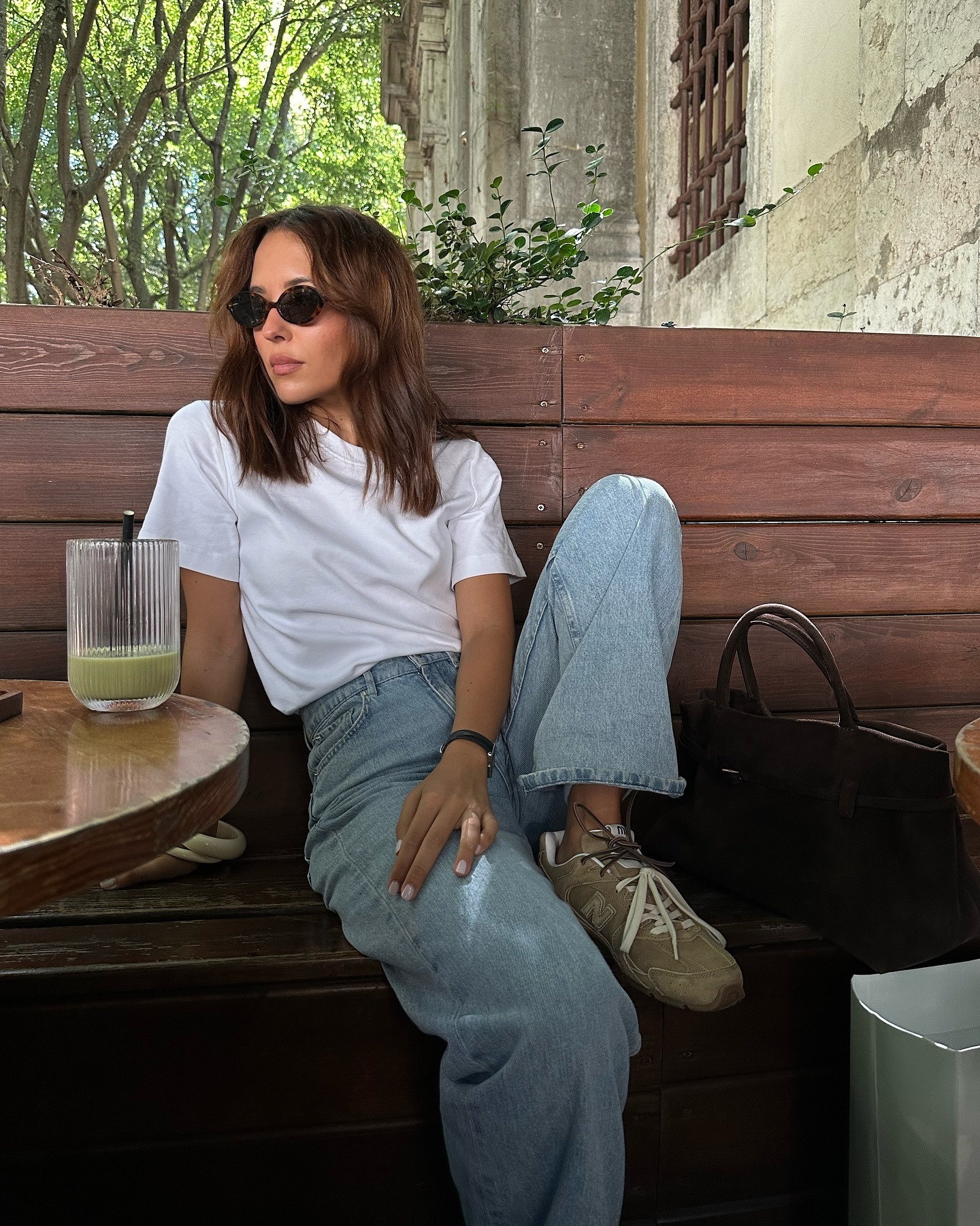 @deborabrosa wearing jeans, New Balance sneakers, and a white shirt