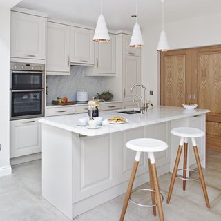 kitchen with white flooring and wall and white cabinet