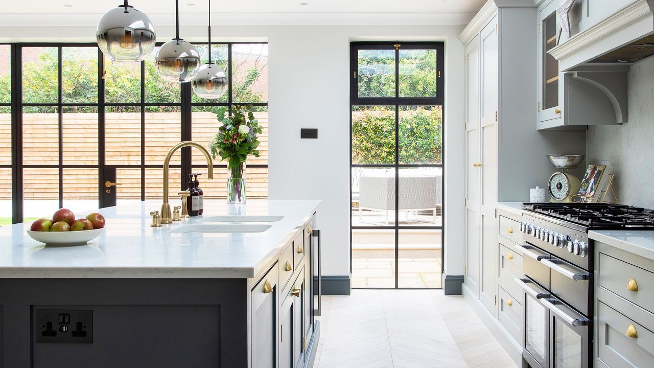 Metal framed glazing, including patio doors and full-height window in contemporary kitchen