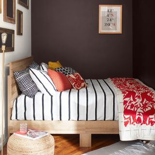 tiny guest room ideas, small bedroom with chocolate brown walls gallery wall, cushions, stripe bedding