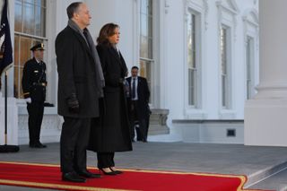 Kamala Harris stands with Doug Elmhoff at the white house