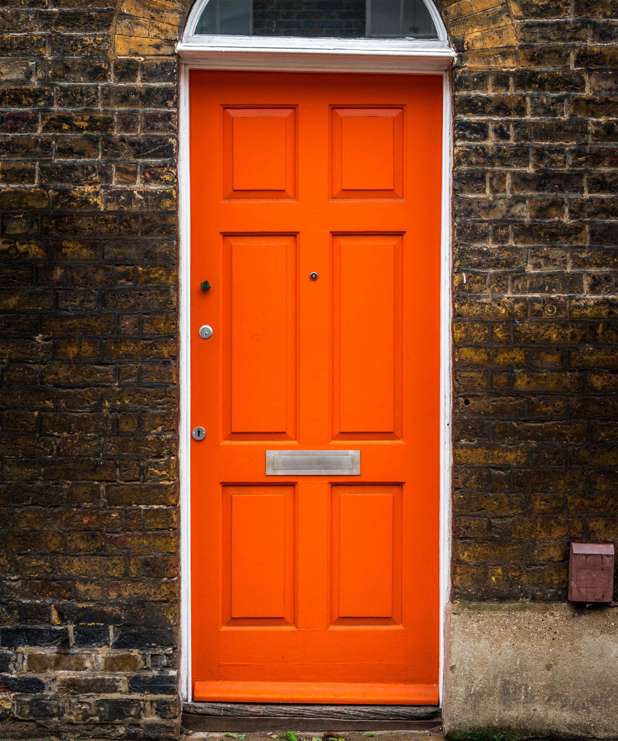 A bright orange front door