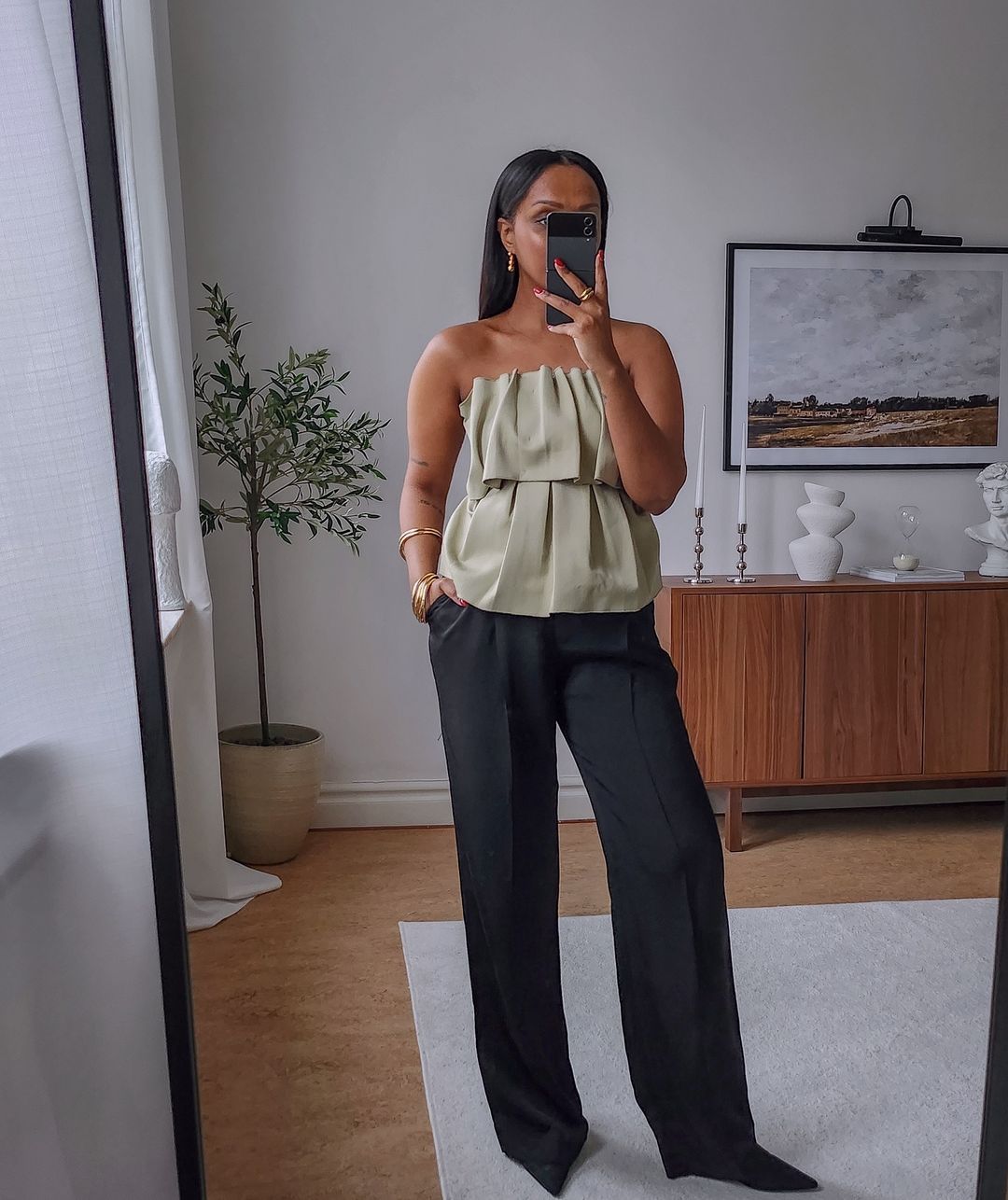@femmeblk wearing strapless top and trouseers