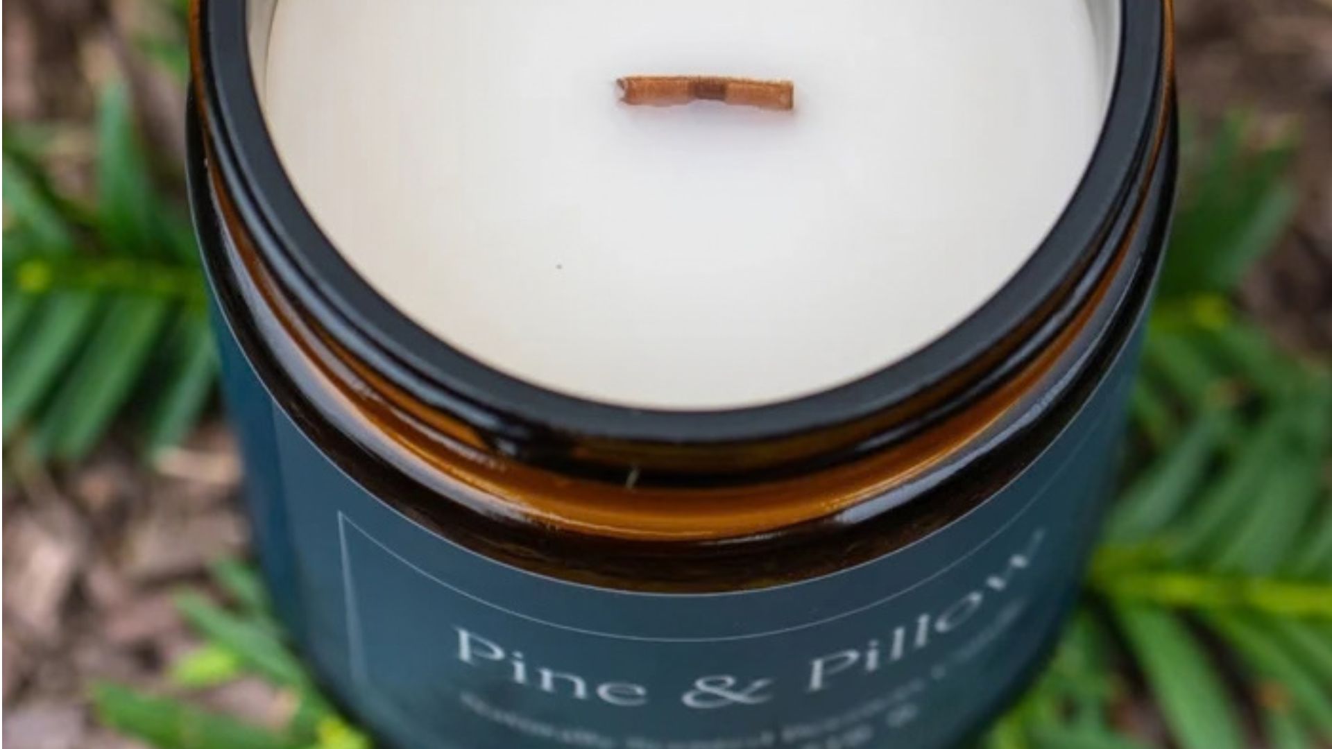 A look at the wax base and cherry wood wick of the Naturepedic Pine &amp;amp; Pillow Candle.