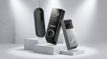 Three video doorbells on light gray platforms with studio lighting