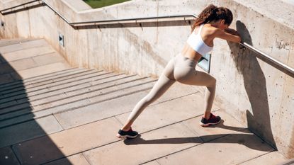 A woman trying exercise snacking, leaning against a wall after a workout