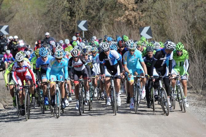 The peloton takes on one of the early dirt sections of the race