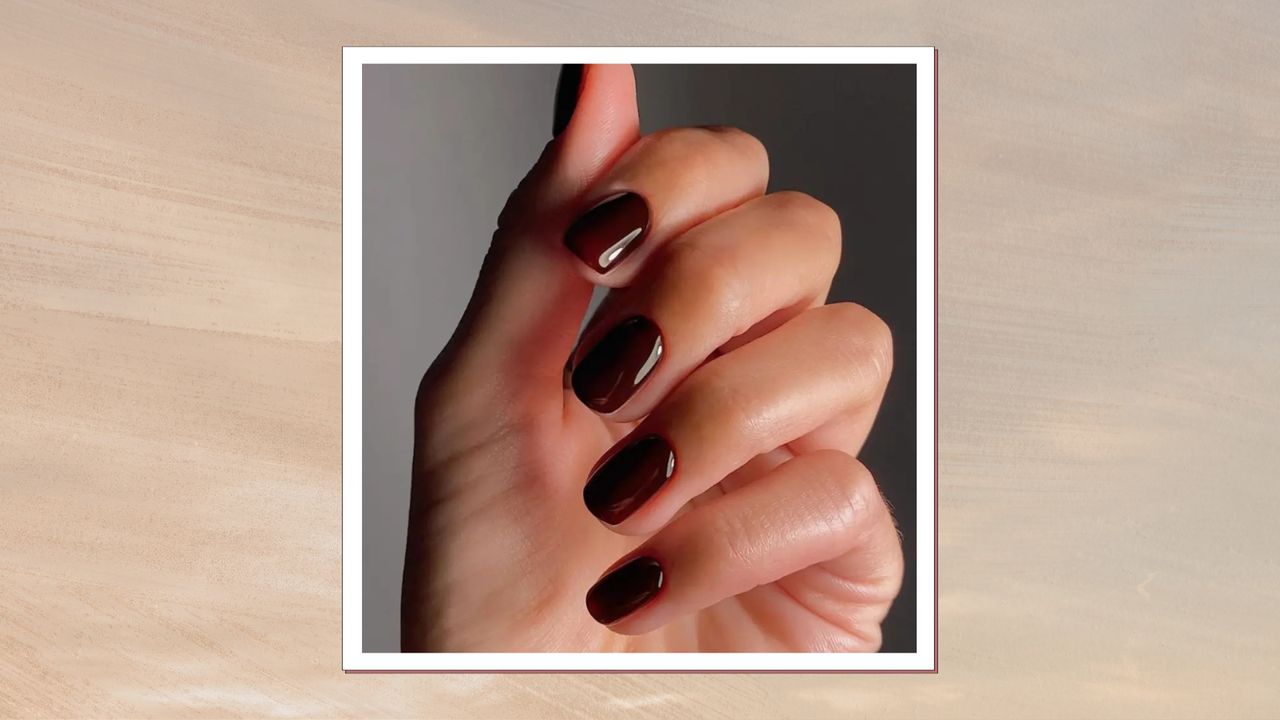 A hand with dark maroon nails - created by nail artist, Mateja Novakovic (@matejanova) - is pictured against a grey backdrop/ in a beige and grey template