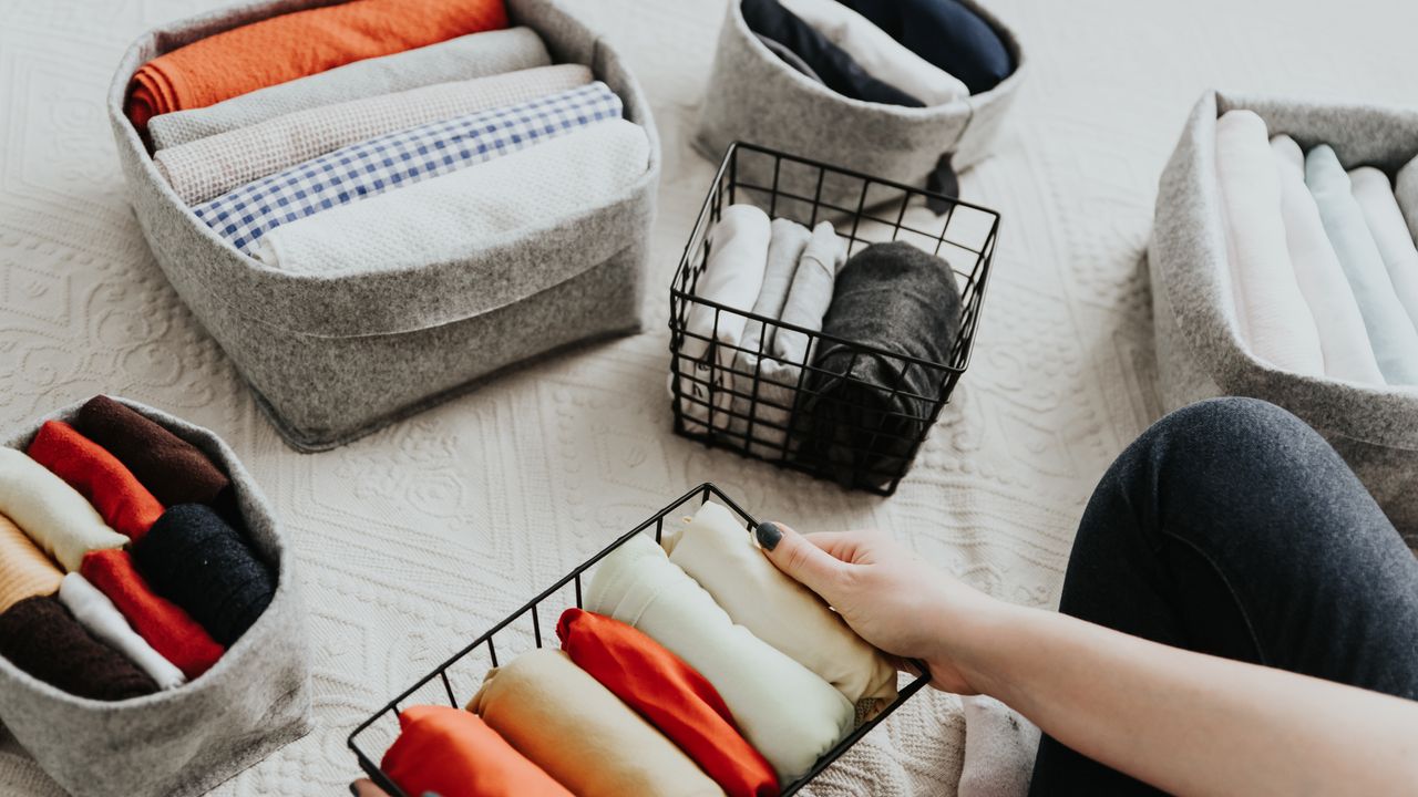 Clothes folded into grey storage cubes