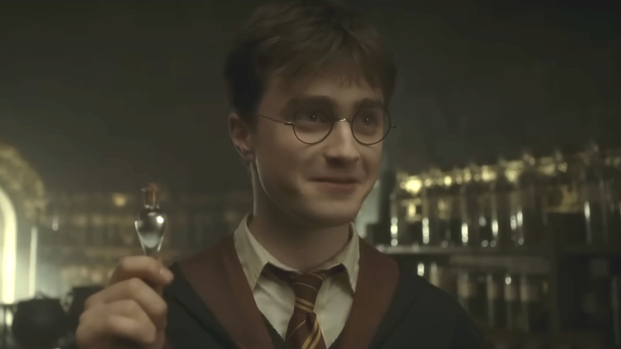 Harry (Daniel Radcliffe) holds liquid luck in Harry Potter and the Half-Blood Prince.