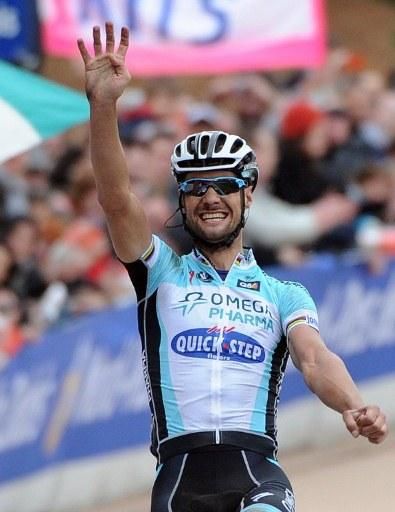 Tom Boonen lets everyone know he's just won Paris-Roubaix for the fourth time, tying the record set by Roger De Vlaeminck.