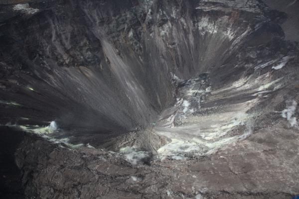  On Aug.1, scientists with the USGS Hawaiian Volcano Observatory snapped this photo of the Kilauea Volcano and the small, green patch of water at the bottom of its crater. 