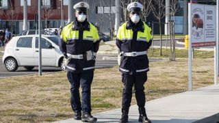 The national military corps stand outside Schiavonia hospitals that were being quarantined in the city of Vo Euganeo in Italy on Feb. 22, 2020.