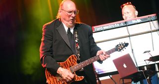 Steve Cropper wears a black suit and tie as he plays his Peavey T-style to honor Otis Redding at the soul legend&#039;s 75th birthday concert in 2016.