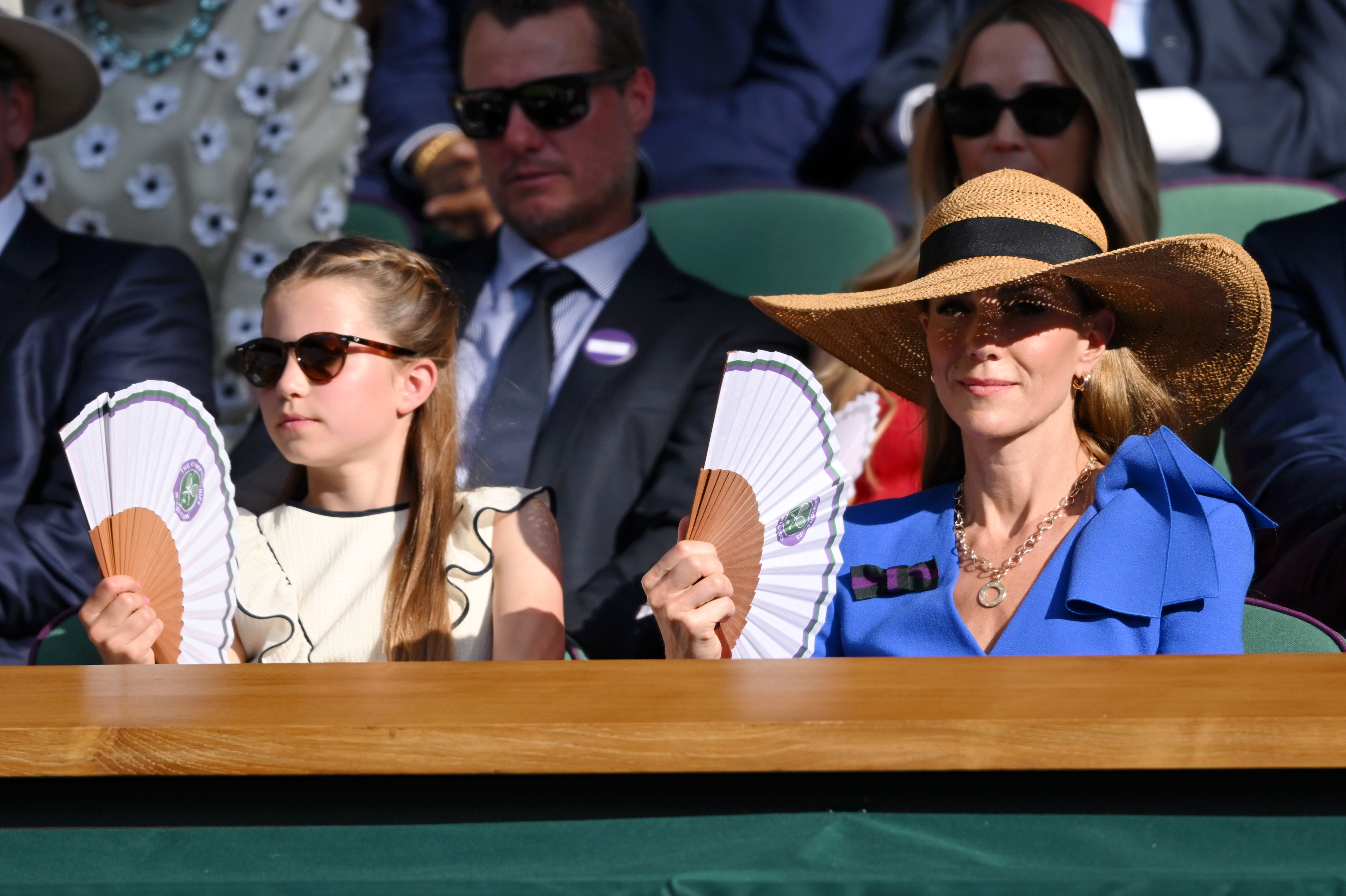 Princess Charlotte fans her mom Kate Middleton at Wimbledon as they watch the tennis tournament during a heat wave