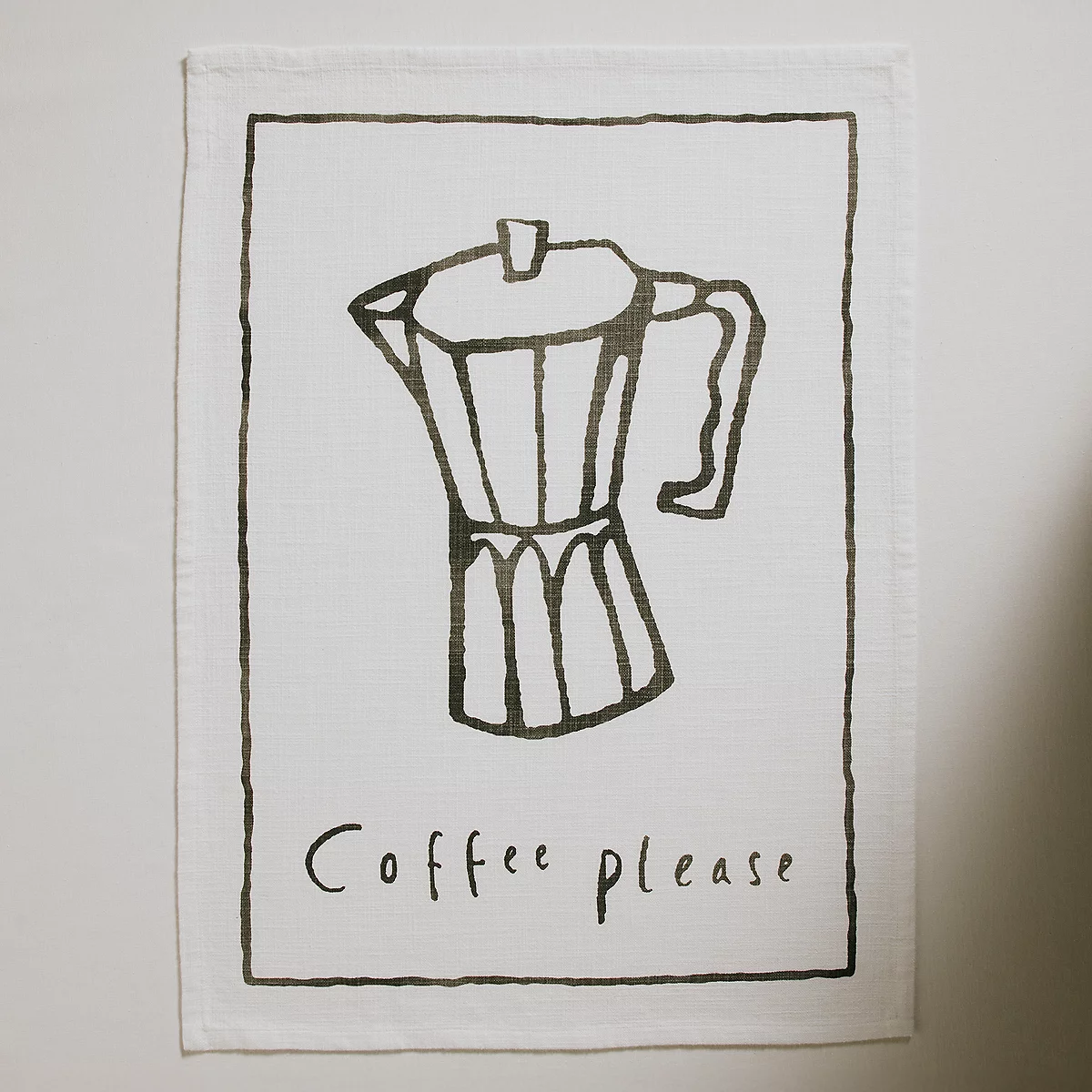 Tea towel with 'coffee please' on it
