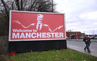 A billboard showing an image of Sir Jim Ratcliffe outside Old Trafford in December 2023.