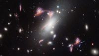 A telescope image showing many distant galaxies, with some forming a question mark-like shape in the middle