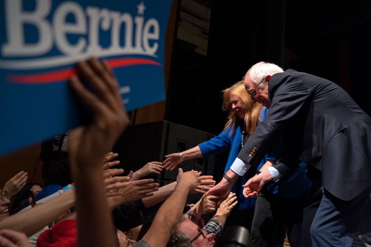 TOPSHOT - Democratic presidential hopeful Vermont Senator Bernie Sanders (R) and his wife Jane O&amp;#039;Meara Sanders shake hands with supporters after Sanders addressed a rally at the Abraham Chave