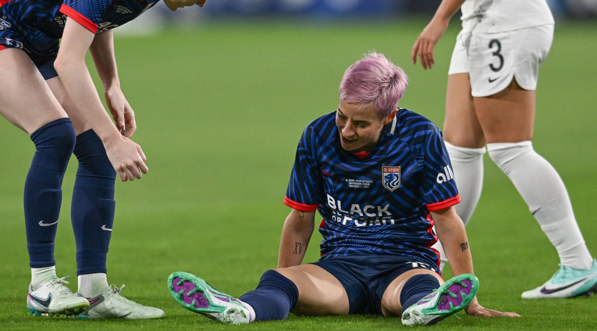 OL Reign&#039;s US midfielder #15 Megan Rapinoe reacts on the pitch after an injury in the early minutes of the first half of the National Women&#039;s Soccer League final match between OL Reign and Gotham FC at Snapdragon Stadium in San Diego, California, on November 11, 2023. US women&#039;s football icon Megan Rapinoe limped out of the final game of her storied career, suffering a suspected torn Achilles tendon less than three minutes into the National Women&#039;s Soccer League Final. (Photo by Robyn Beck / AFP) (Photo by ROBYN BECK/AFP via Getty Images)