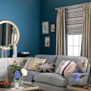 Blue living room with grey and blue patterned curtains and blinds