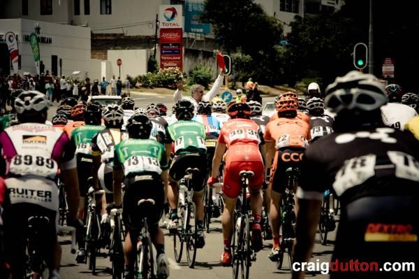 The race is stopped as organisers try to get cars off the route