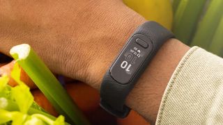 Man's wrist wearing Garmin Vivosmart 5