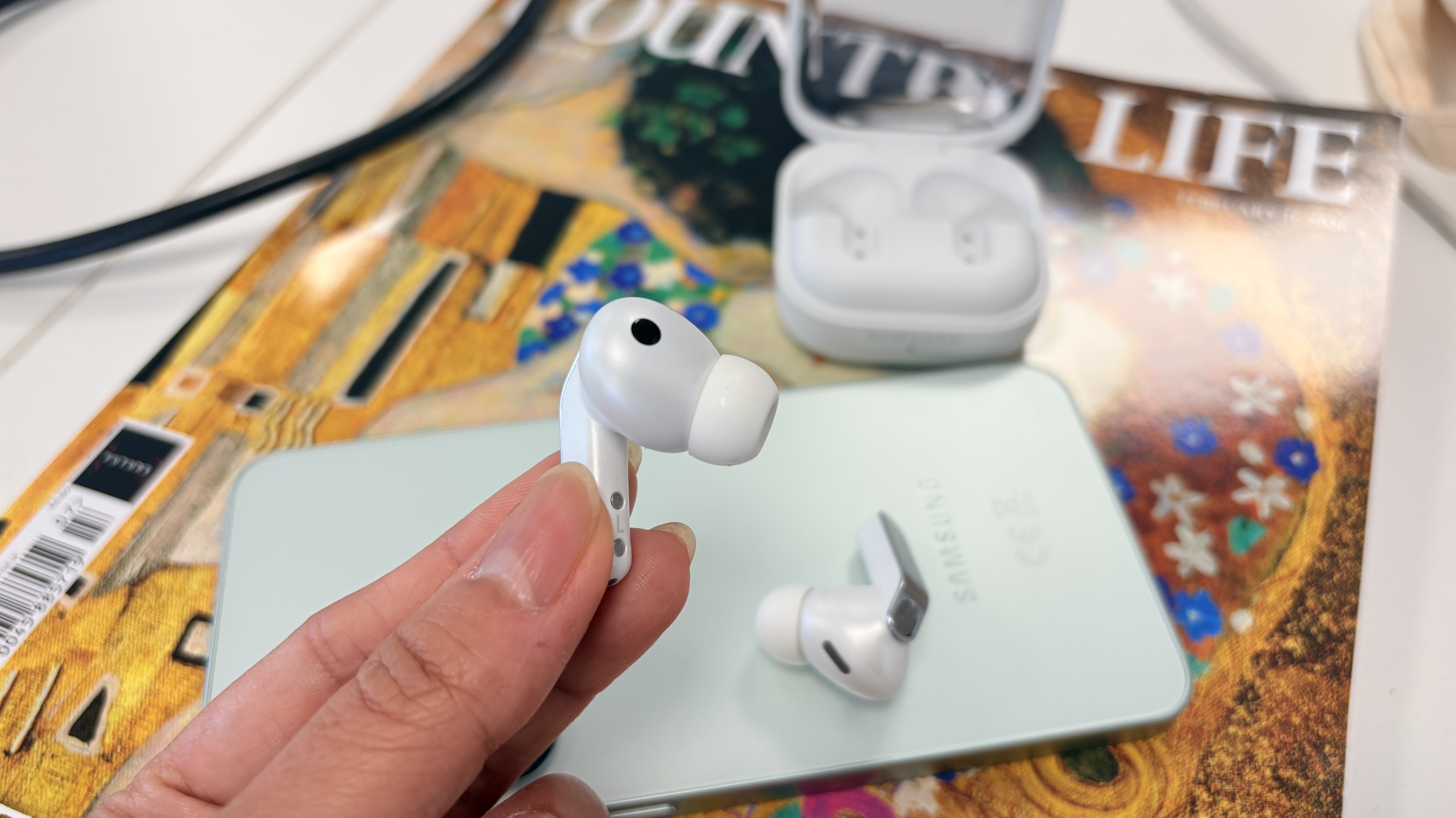 Samsung Galaxy Buds 4 Pro wireless earbuds in white finish with S25 smartphone
