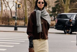 Woman in brown cardigan and gray sweater.