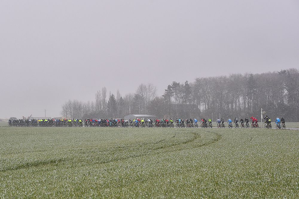 Snow falls on the peloton during stage 1 at Paris-Nice.
