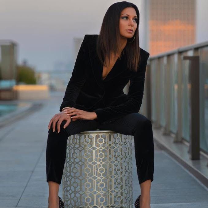 Anjula Acharia wearing a black Dolce & Gabbana suit