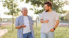 An older, shorter male talking to a younger, taller male