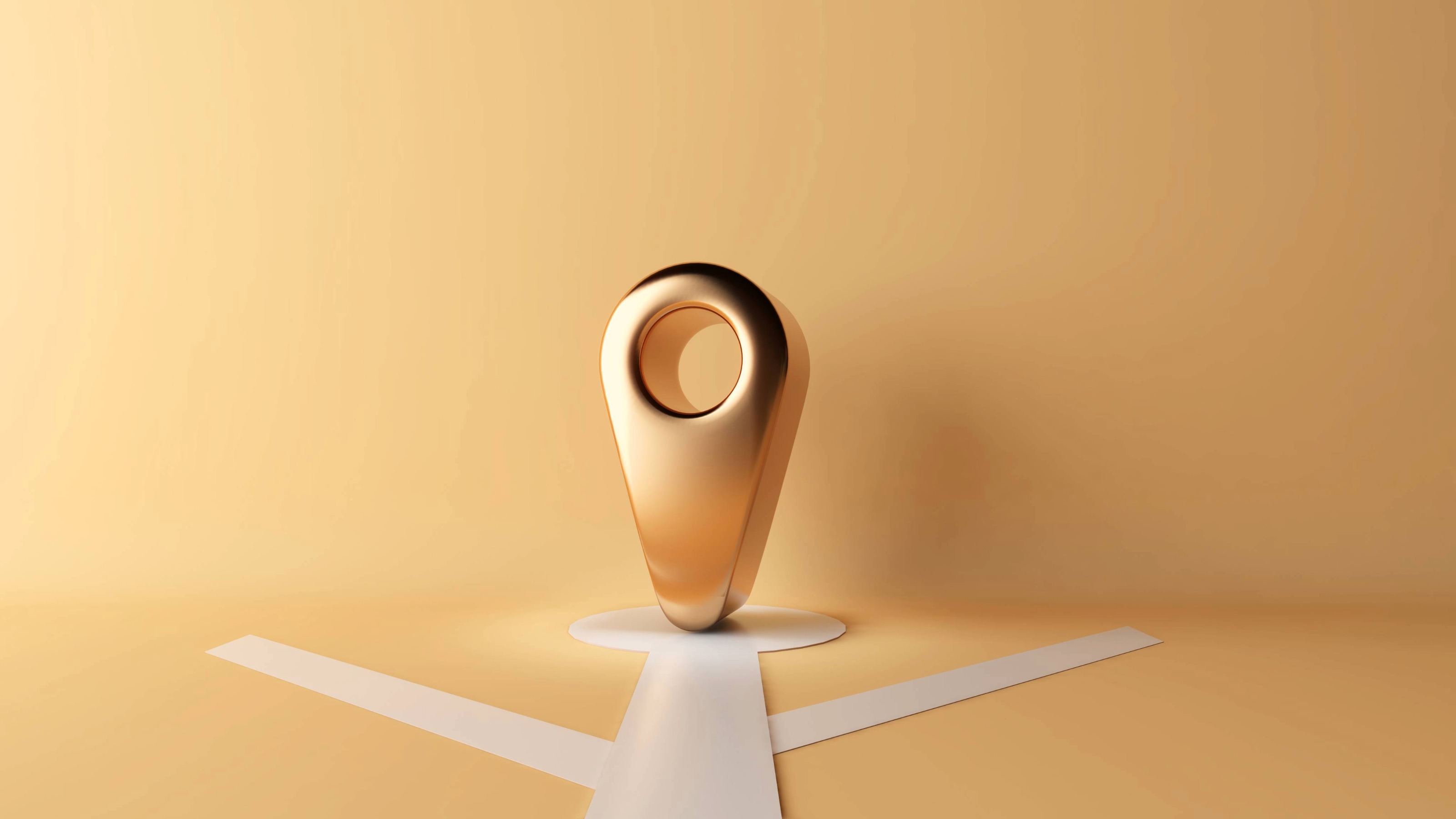 3D gold location symbol standing on basic representation of a map on a gold background