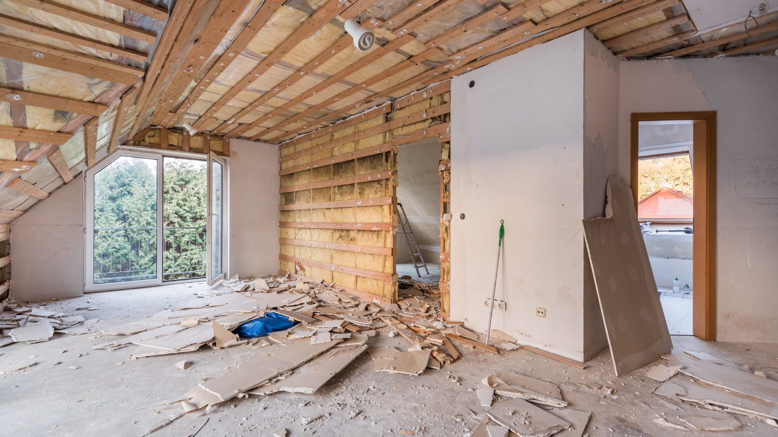 inside of house mid-renovation with walls knocked down and ceiling exposed