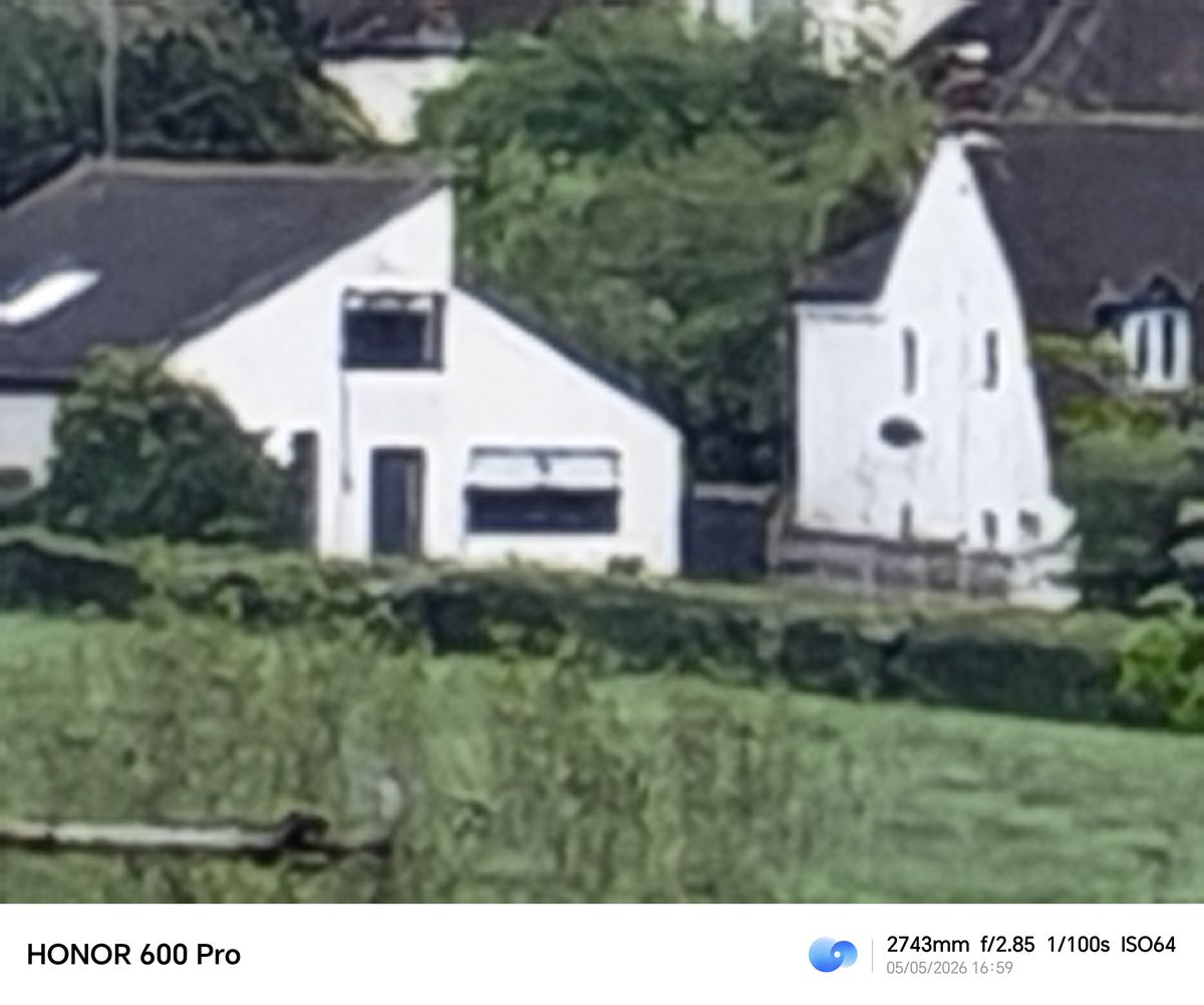 Extreme digital zoom image of distant white houses captured with the Honor 600 Pro