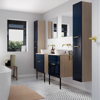 bathroom with white wall wooden cabinet with black door wash basin and designed floor