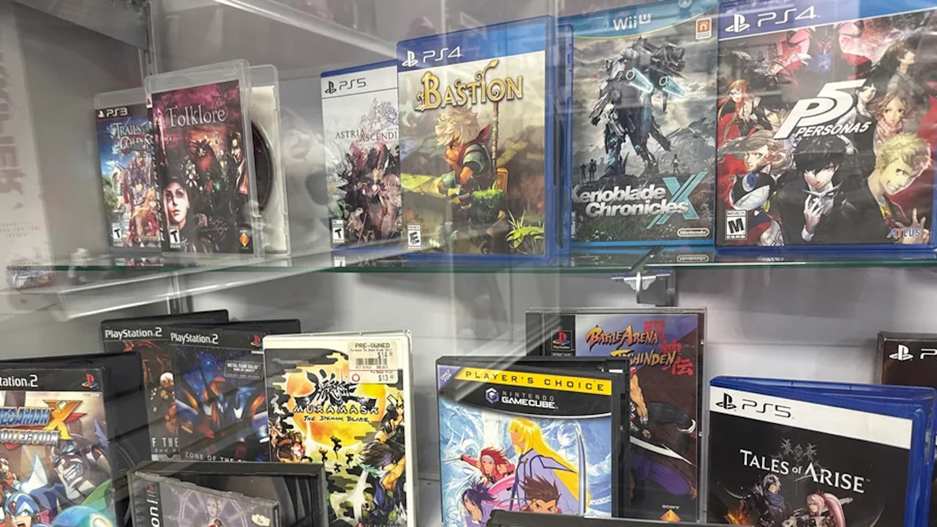 Photographs of custom game store collection display with dozens of games and boxes on shelves