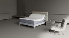 Sleep Number grey bedroom with grey bed, Sleep Number mattress, and grey chair