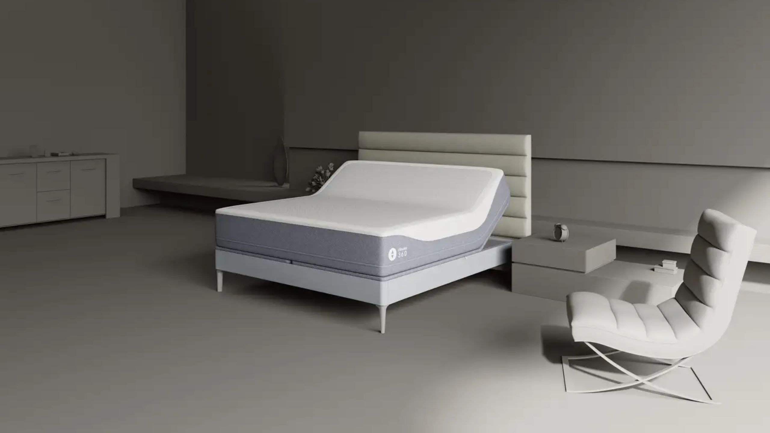 Sleep Number grey bedroom with grey bed, Sleep Number mattress, and grey chair