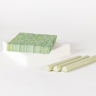 A set of green printed napkins and candles
