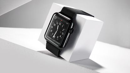 The Best Apple Watch photographed on a white cube and grey background