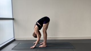 Kelly Turner, a teacher from YogaPose, demonstrates the forward fold move
