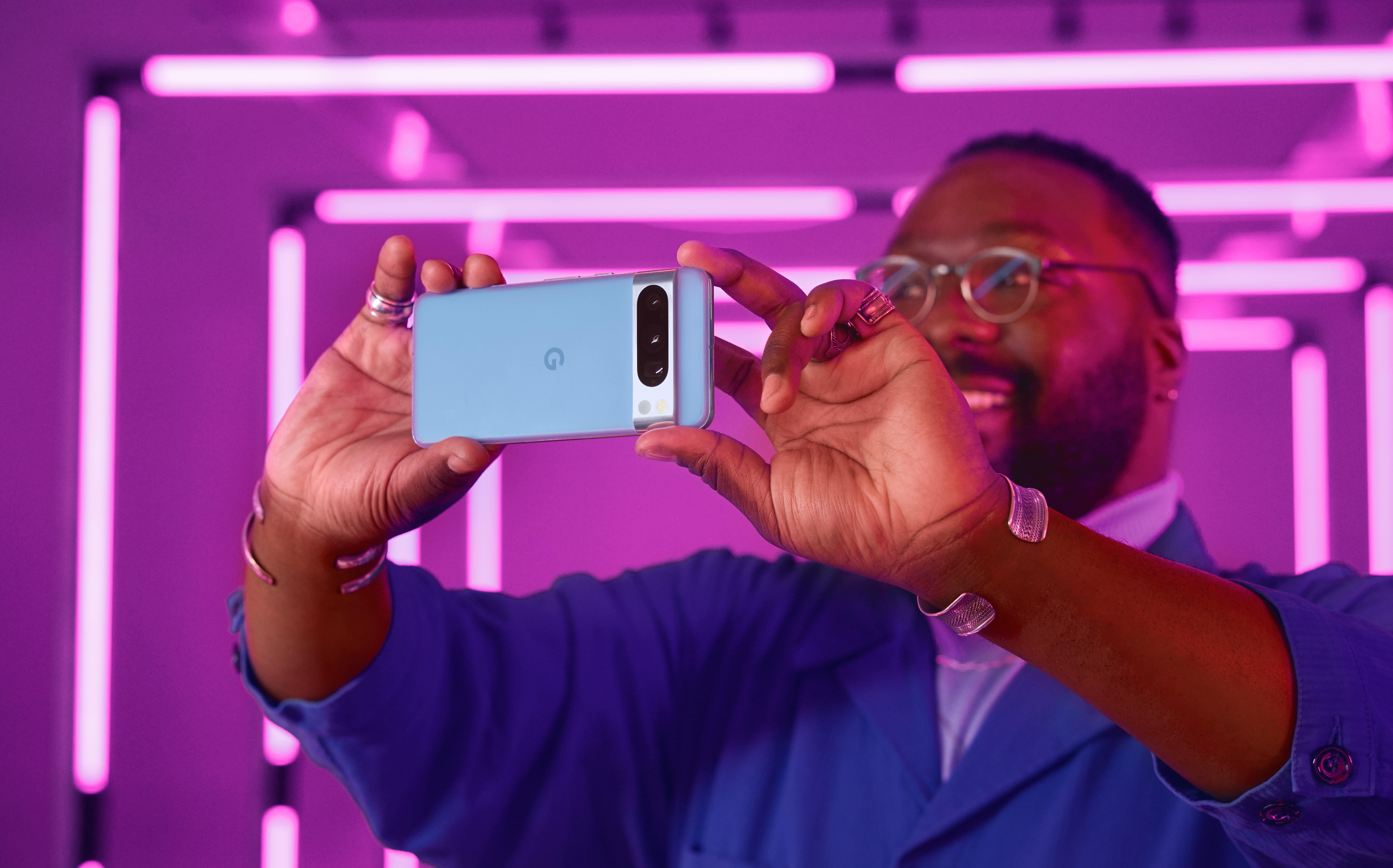 An image of a man holding a Google Pixel 8 Pro