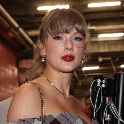 Taylor Swift wearing a plaid mini dress