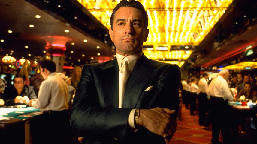 A still from Casino, one of the best new Hulu movies, showing Robert Deniro's character Sam in a casino with his arms folded.