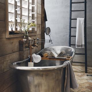 bathroom with wooden and grey wall steel bathtub and blue ladder