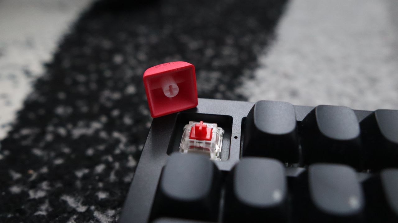 The Keychron Q3 Max gaming keyboard set-up on a desk with the RGB lighting enabled.